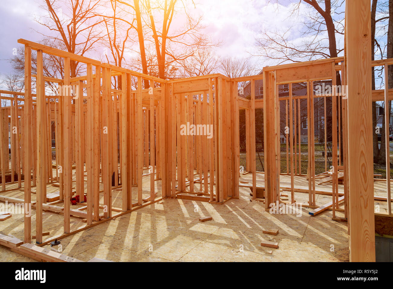 A stick built house under construction New build with wooden and beam framework. Stock Photo