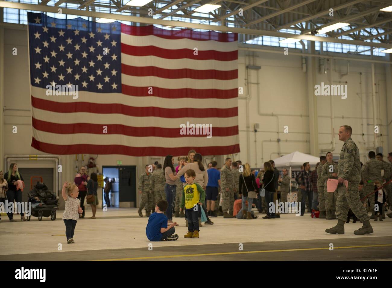 Friends and Families wait at Hangar 25 on Joint Base Elmendorf-Richardson, Alaska April 21 for the 525th Fighter Squadron to return from a 7-month deployment. For many families, this was their first time being separated from their loved ones for an extended period of time. Stock Photo