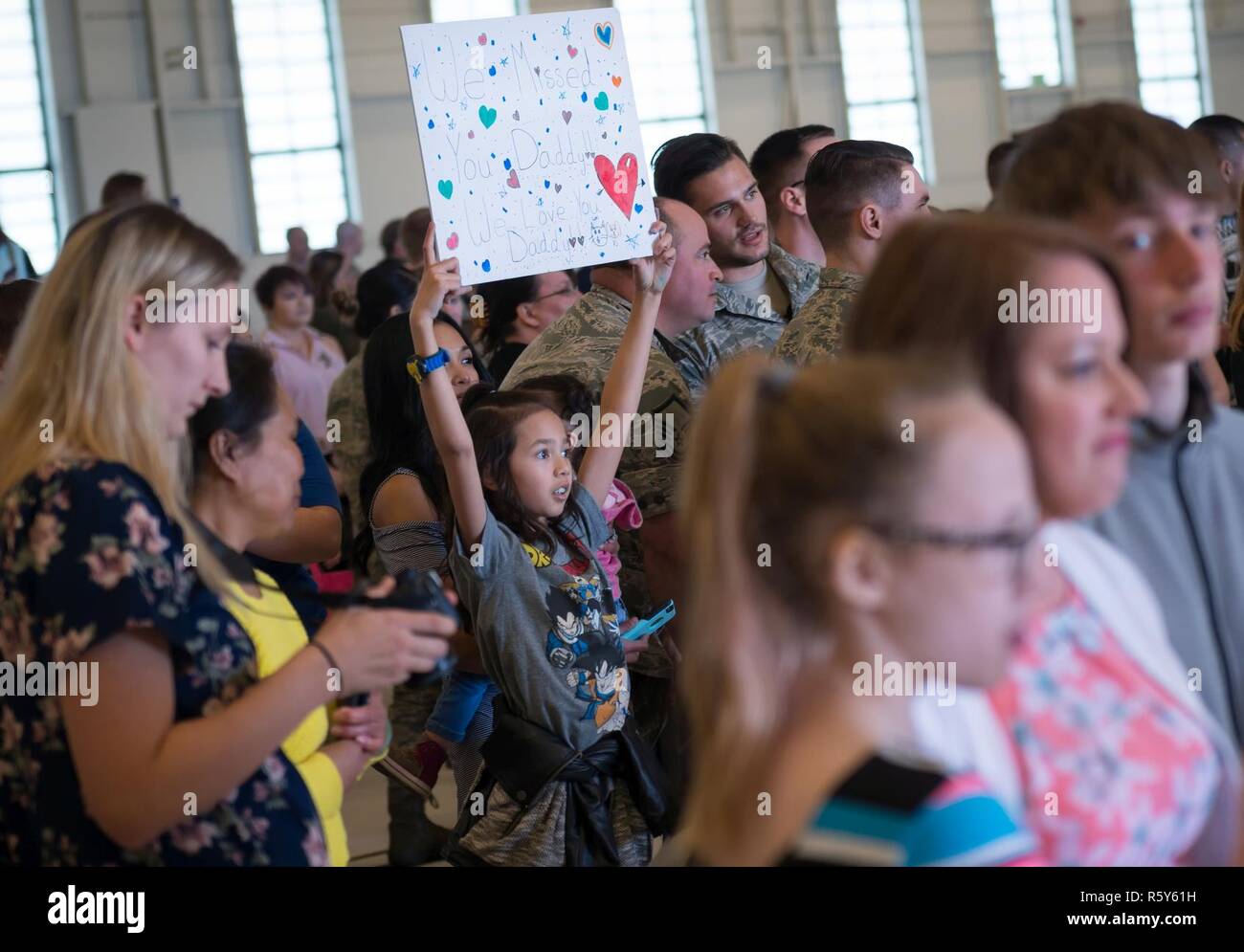 Friends and Families wait at Hangar 25 on Joint Base Elmendorf-Richardson, Alaska April 21 for the 525th Fighter Squadron to return from a 7-month deployment. For many families, this was their first time being separated from their loved ones for an extended period of time. Stock Photo
