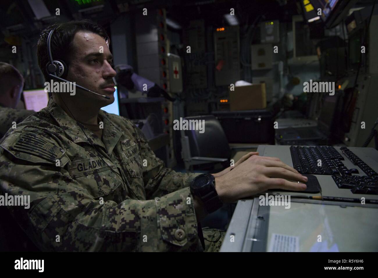 5TH FLEET AREA OF OPERATIONS (April 23, 2017) Air Traffic Controlman 3rd Class Michael Gladwin from Tactical Air Traffic Control Squadron 21 stands watch in the Tactical Air Traffic Control Center aboard the amphibious assault ship USS Bataan (LHD 5). The ship and its ready group are deployed in the U.S. 5th Fleet area of operations in support of maritime security operations designed to reassure allies and partners, and preserve the freedom of navigation and the free flow of commerce in the region. Stock Photo