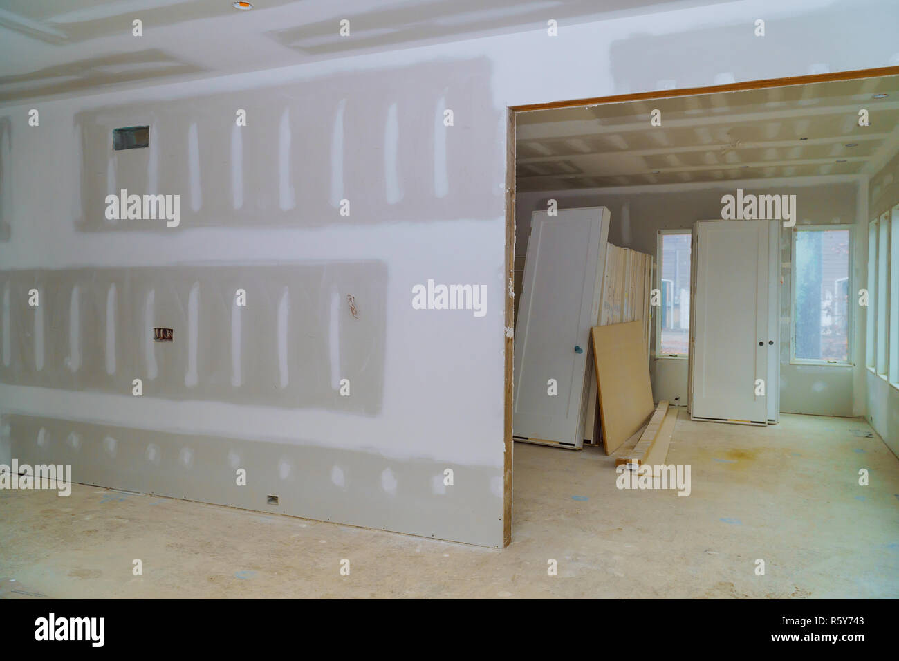 Interior construction of housing project with drywall installed door