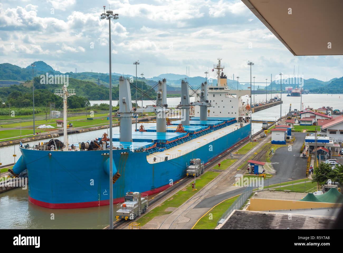 Large cargo ships pass through the Panama Canal locks. This everyday