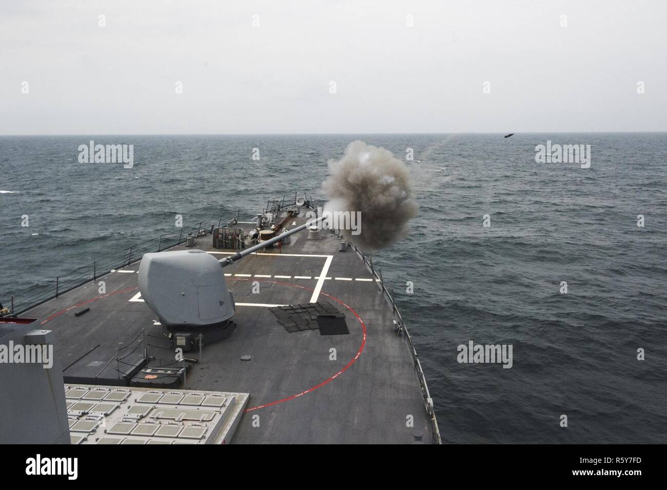SEA OF JAPAN (April 25, 2017) A M160 5-inch gun weapon system fires ordinance on the forward-deployed Arleigh Burke-class guided-missile destroyer USS Fitzgerald (DDG 62) during a bilateral training exercise with the Kongou class guided-missile destroyer JS Choukai (DDG 176) of the Japanese Maritime Self-Defense Force (JMSDF). Exercises like this enhance information sharing and combined maritime defense capabilities to ensure the U.S. and our allies remain ready to defend the region against any provocations. Stock Photo