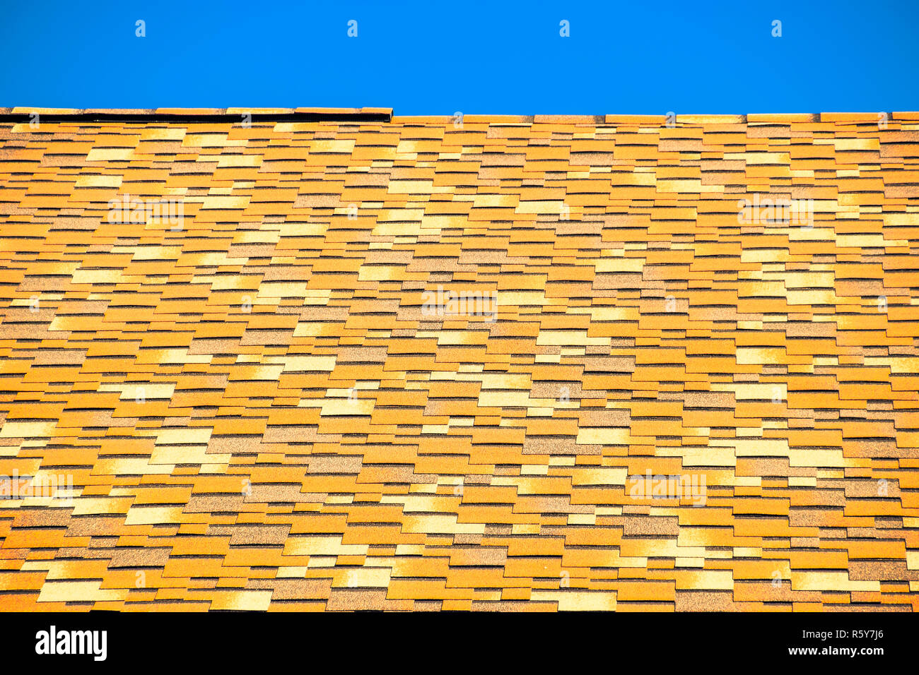 Roof from multicolored bituminous shingles. Patterned bitumen shingles