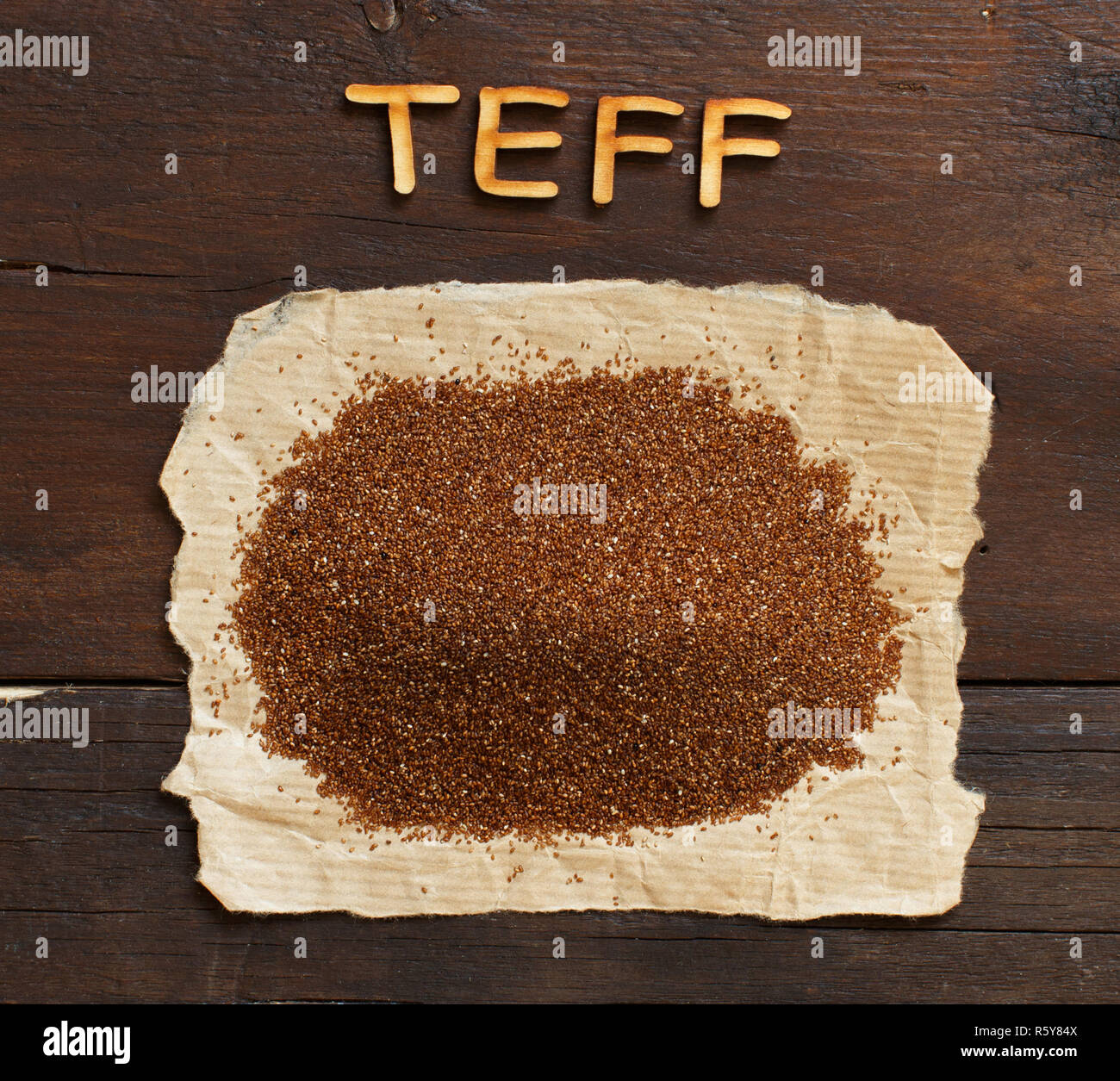 Pile of uncooked teff grain with wooden word Stock Photo Alamy
