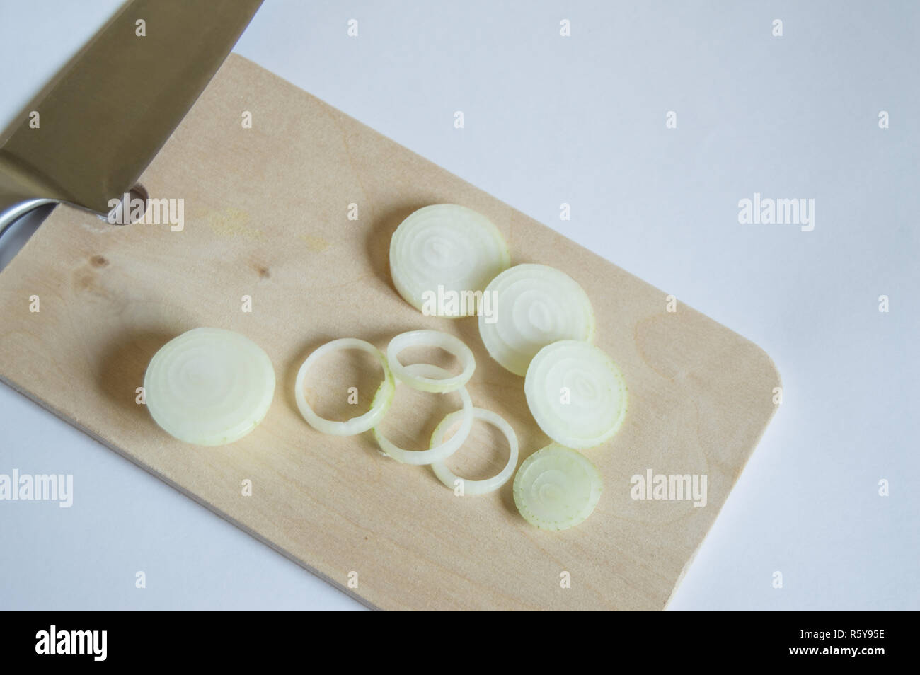 Fresh onion sliced on a cutting Board with a kitchen knife Stock Photo ...