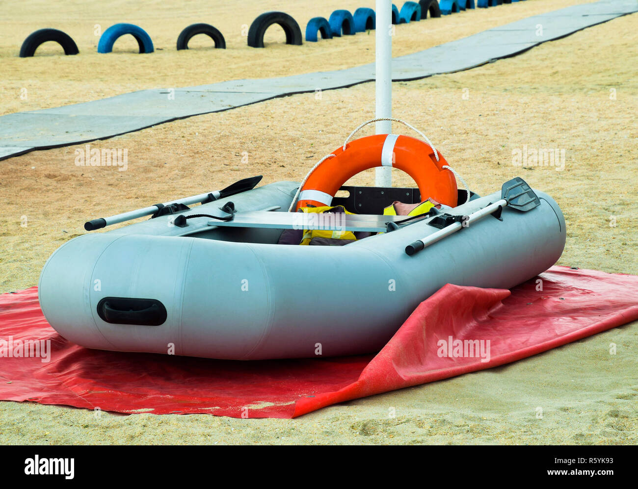 Inflatable Rescue Boat. Gray inflatable boat on the beach in the Stock Photo