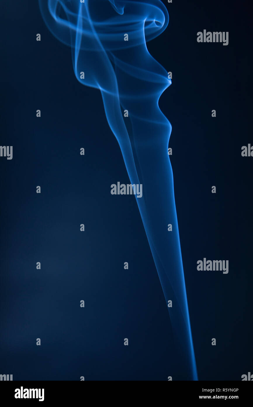 Abstract blue smoke swirls on dark background Stock Photo - Alamy