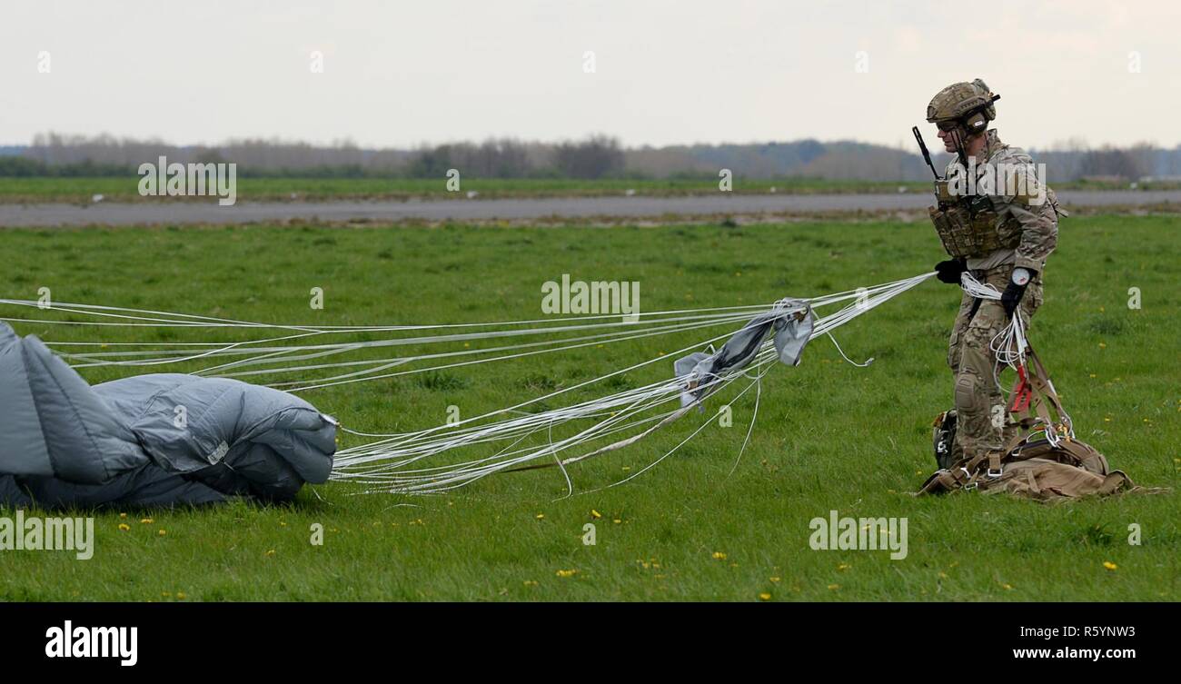 A U.S. Air Force Air Commando, assigned to the 321st Special Tactics  Squadron repacks a parachute after performing a static line jump, April 13,  2017 over RAF Sculthorpe, England. The mission allowed