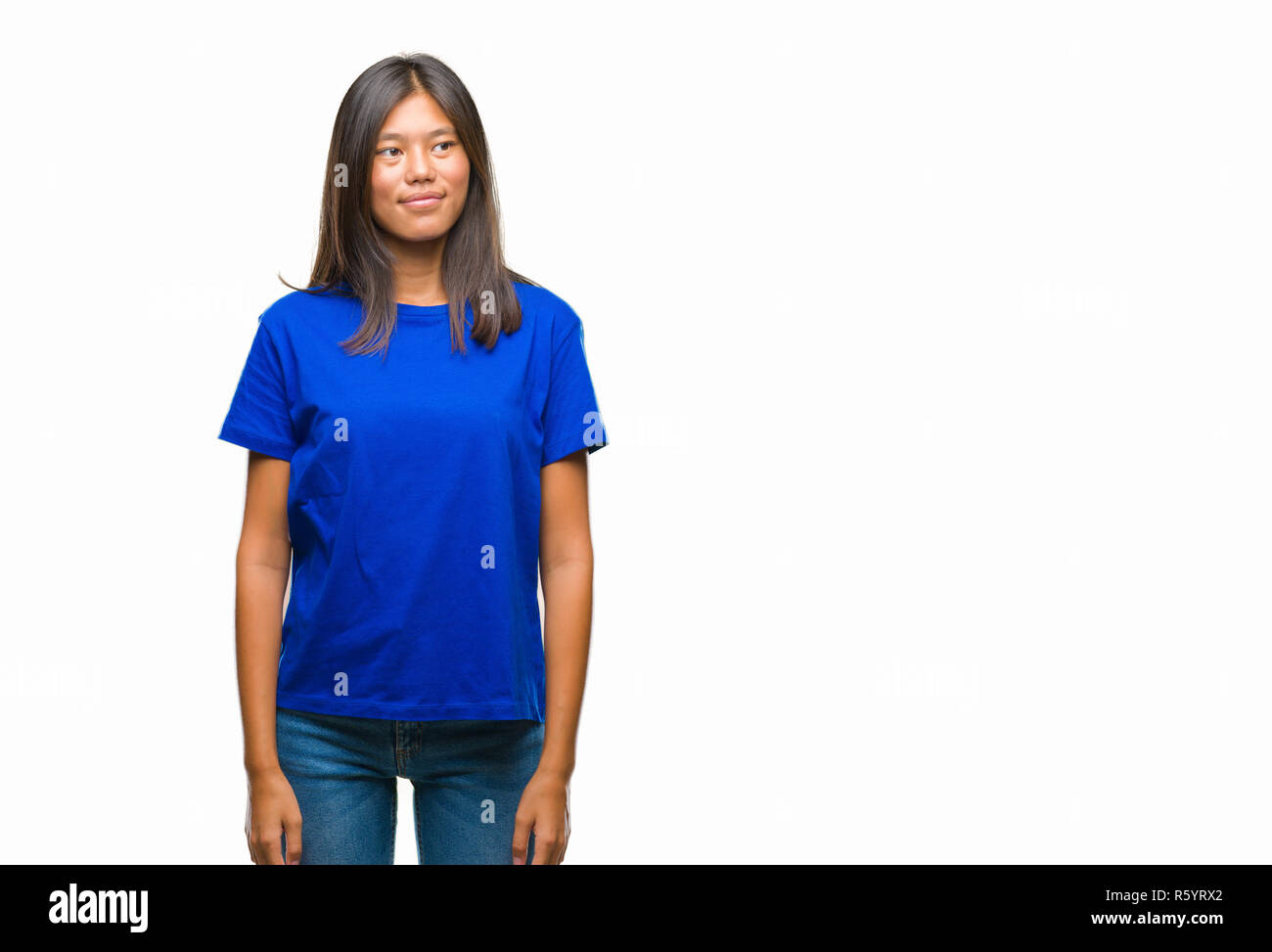 Young asian woman over isolated background smiling looking side and staring away thinking. Stock Photo