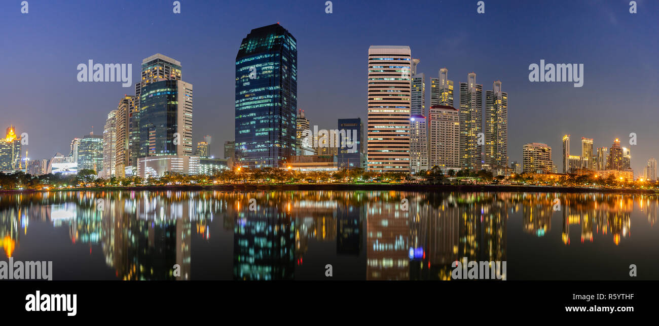 Panorama building city in business area night scene with river reflection in Bangkok, Thailand. Stock Photo
