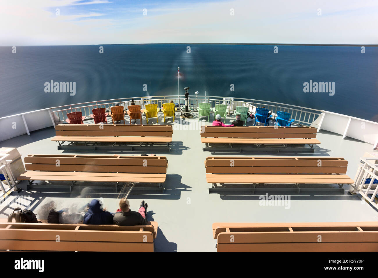 Passengers on the top deck of the Chi-Cheemaun ferry as it departs South Baymouth Ferry Terminal on a sunny Spring day, Ontario, Canada Stock Photo