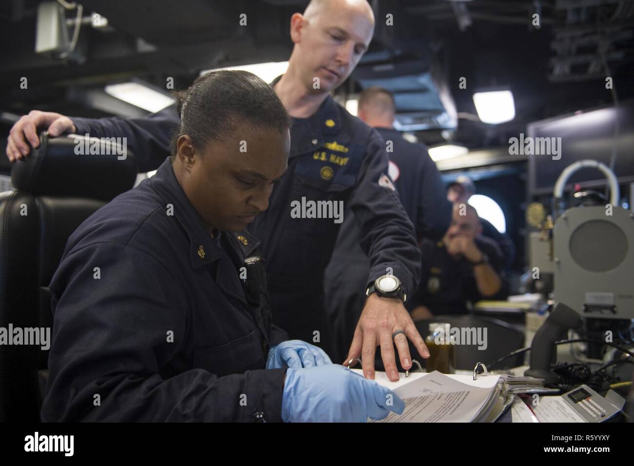 CHANGI NAVAL BASE, Singapore (April 24, 2017) Chief Engineman Tramaine Londo evaluates lube oil on the bridge during an assessment with Engineering Assessments Pacific as part of Engineering Operations Certification aboard littoral combat ship USS Coronado (LCS 4). Coronado is on a rotational deployment in U.S. 7th Fleet area of responsibility, patrolling the region's littorals and working hull-to-hull with partner navies to provide 7th Fleet with the flexible capabilities it needs now and in the future. Stock Photo