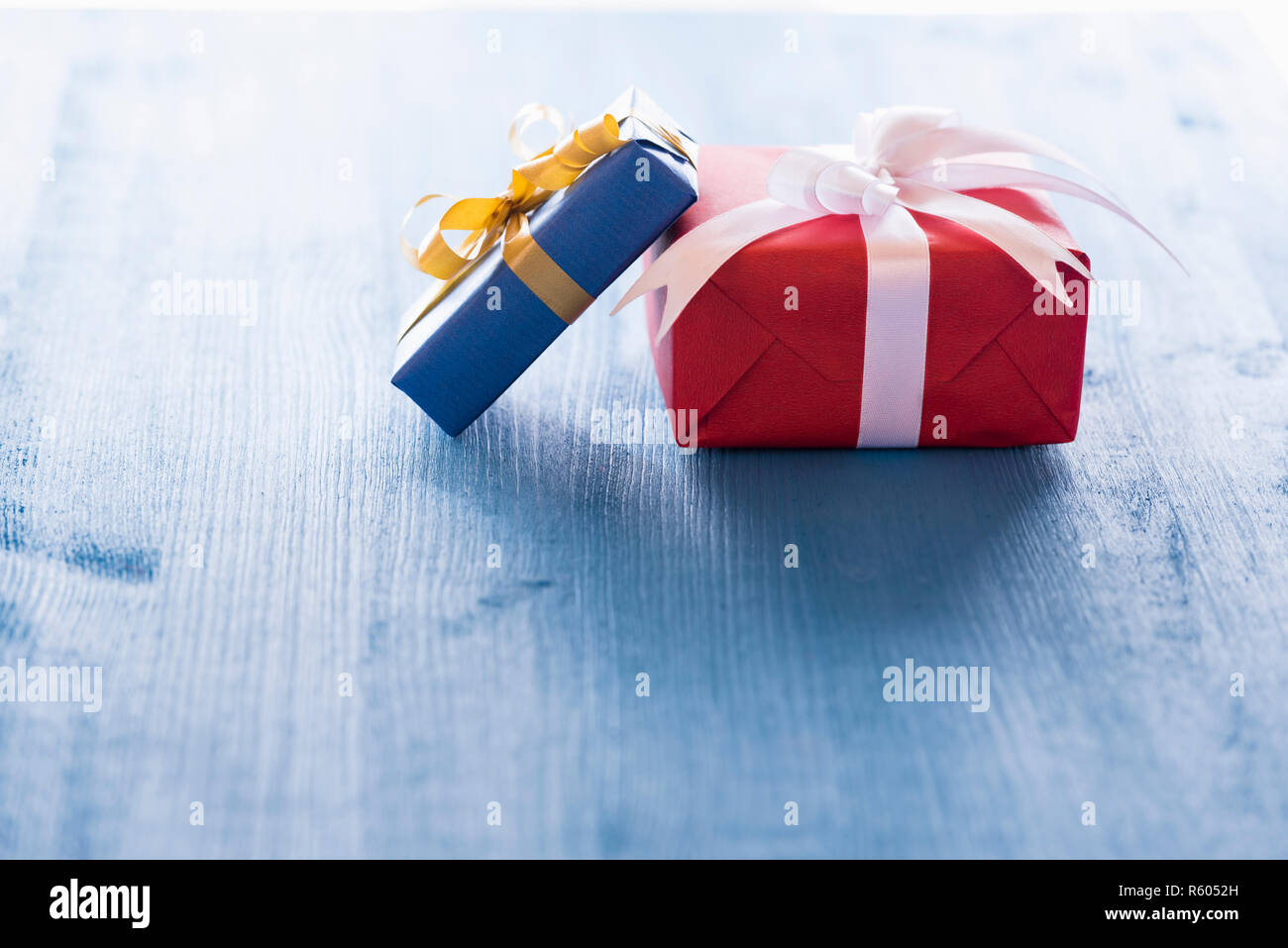 Two gift boxes on blue table Stock Photo