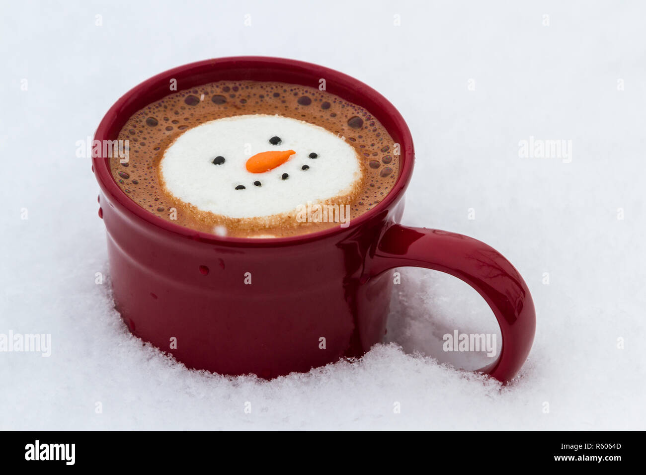 hot cocoa beverage mixed with Irish whiskey garnished with a smiling snow-person marshmallow Stock Photo