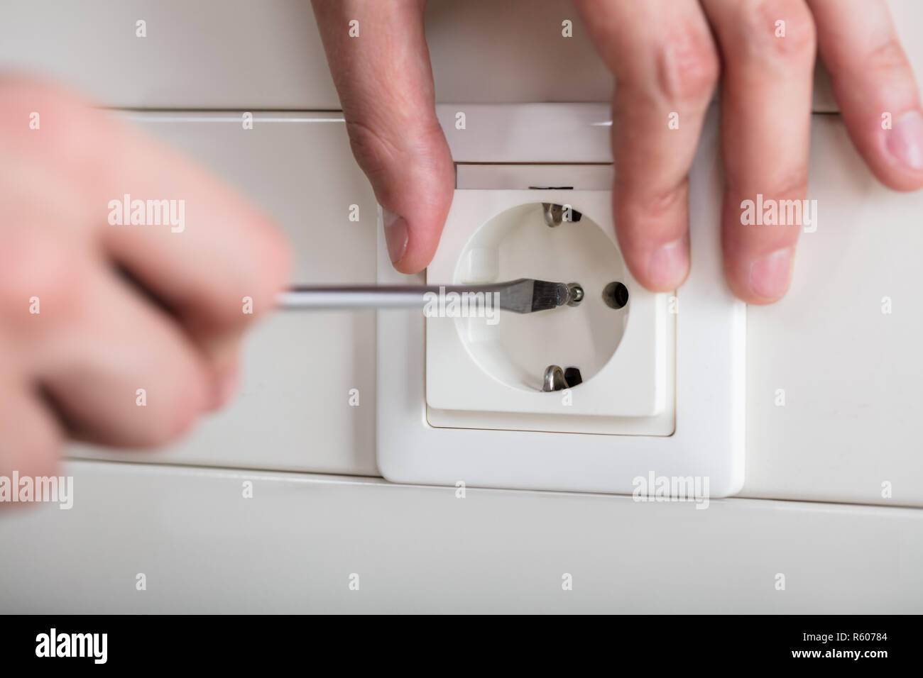 Person's Hand Fixing Socket Stock Photo