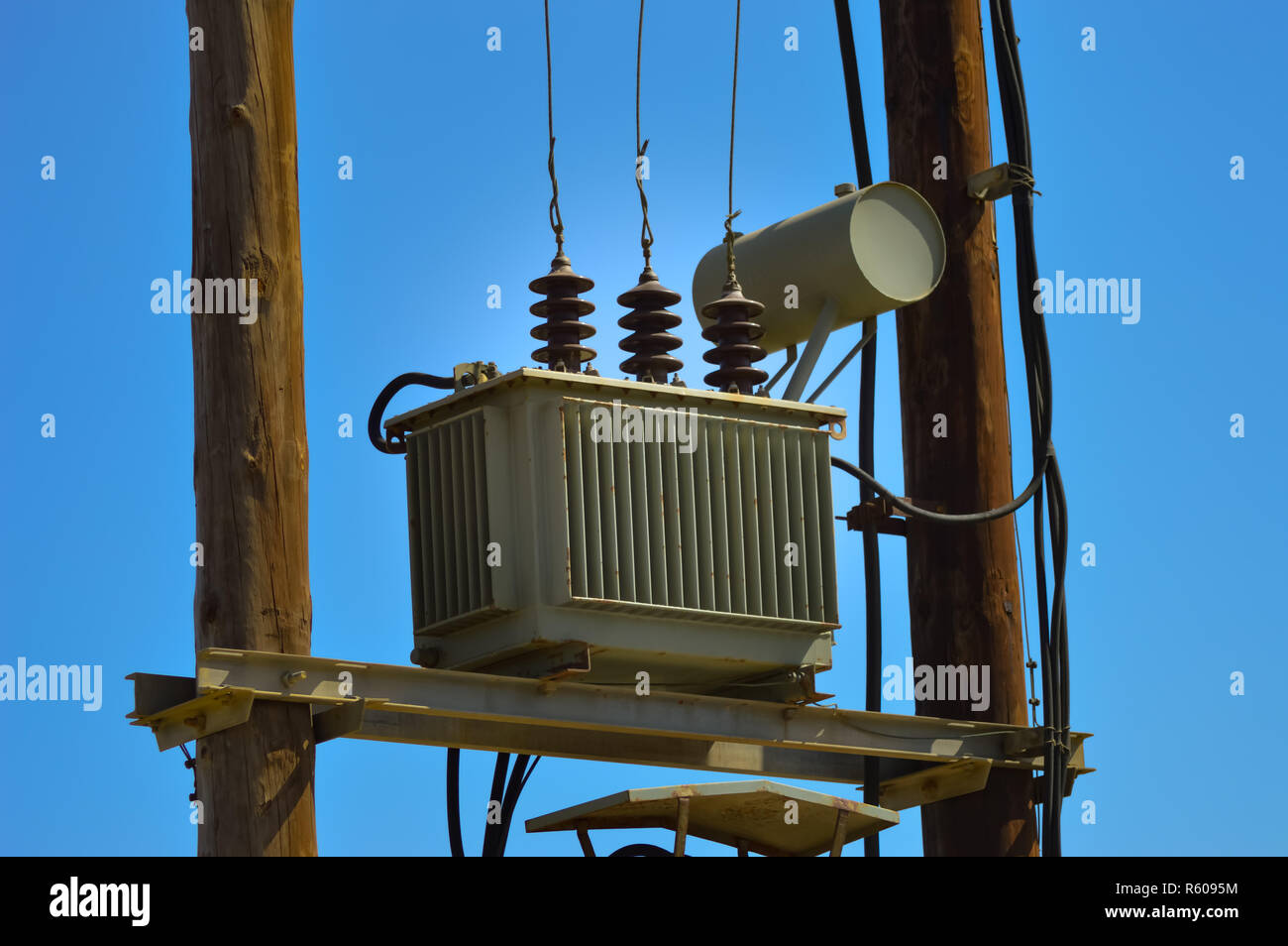 Electric transformer on wooden pylons Stock Photo