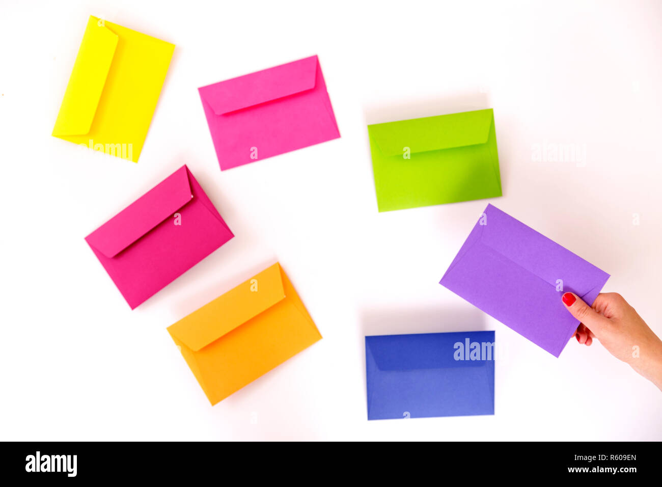 Different colored envelopes on the table. Stock Photo