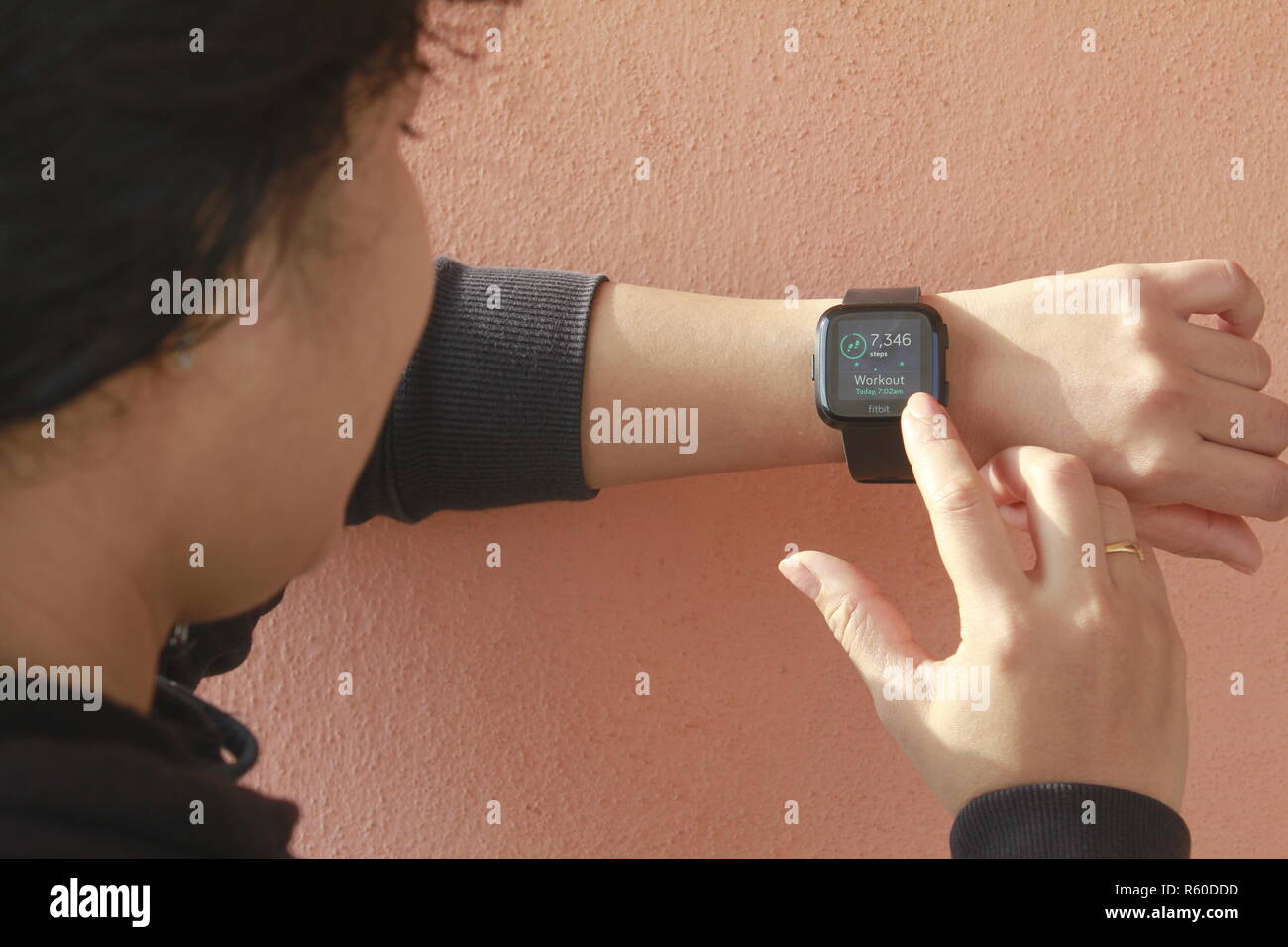 Woman using smart watch (Fitbit) Stock Photo