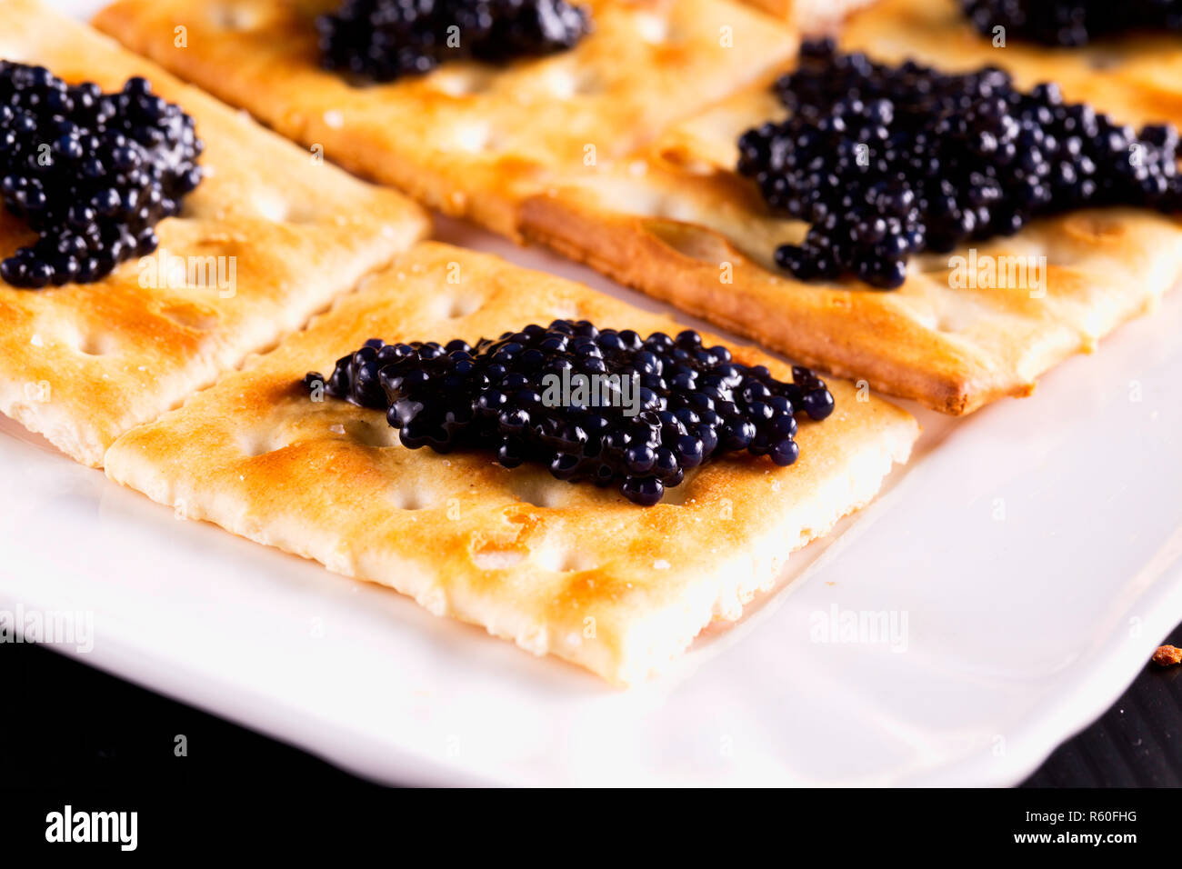 Caviar over crackers Stock Photo Alamy