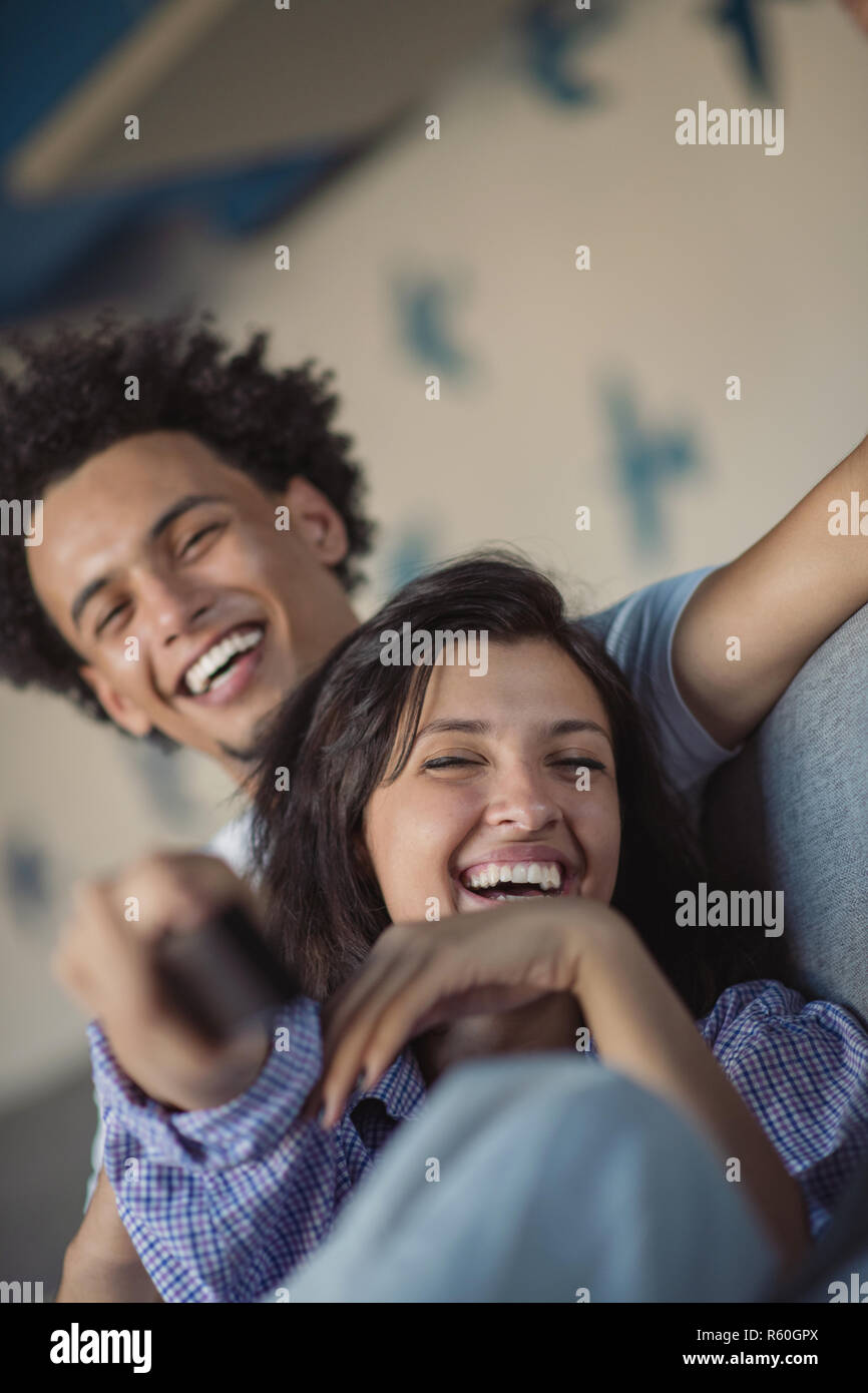 Young black couple relaxing on couch and smiling at camera Stock Photo ...