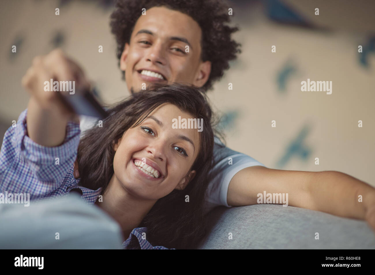 Young black couple relaxing on couch and smiling at camera Stock Photo ...