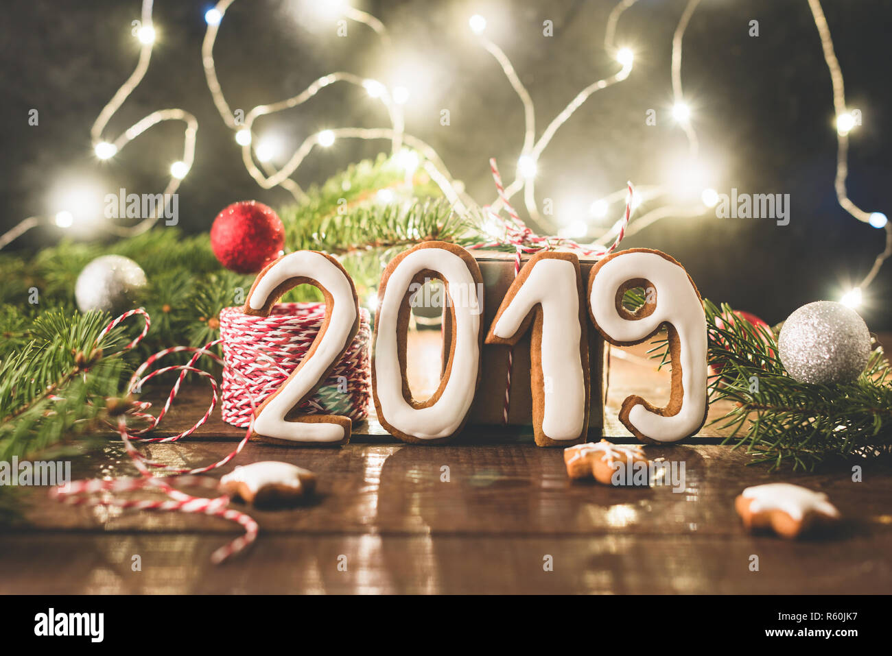 2019 greeting made of cookies and christmas lights. Christmas or New Year banner, decorations, greeting card Stock Photo