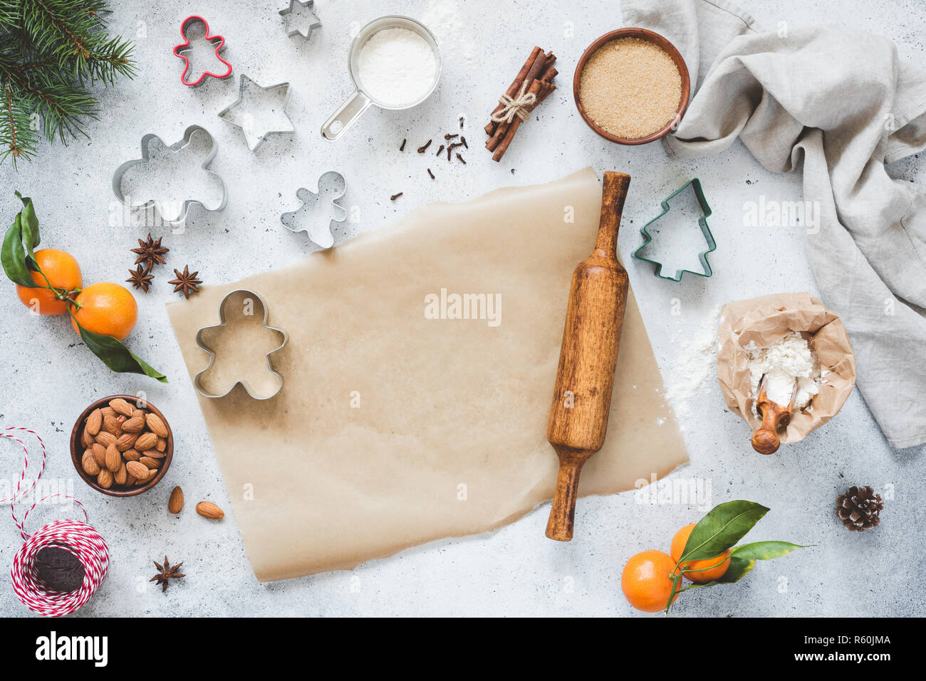 https://c8.alamy.com/comp/R60JMA/christmas-baking-concept-cookie-cutters-rolling-pin-baking-paper-and-ingredients-on-concete-background-top-view-gingerbread-cookies-baking-copy-s-R60JMA.jpg