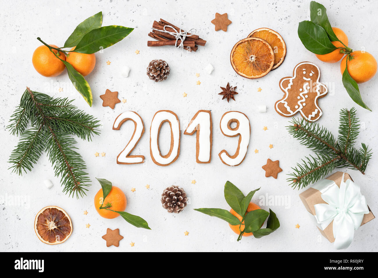 2019 greeting with gingerbread cookies, fir tree, decorations. New Year or Christmas greeting card, design template. Flat lay composition Stock Photo