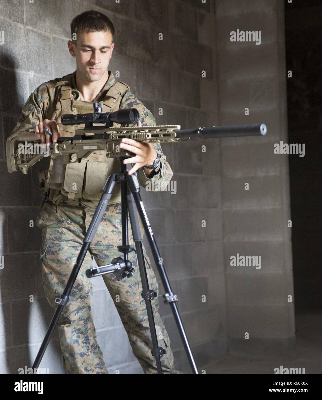 A Marine mounts his weapon to a tripod during a Military Operations on Urba...