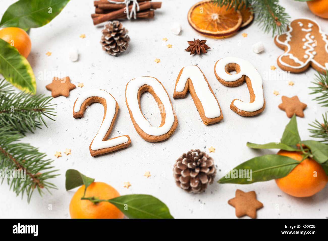 2019 made of gingerbread cookies and decorations on white concrete background. Christmas or New Year greeting card template Stock Photo