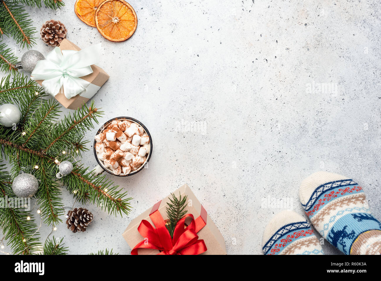 Christmas background with fir tree, hot chocolate, gift box on concrete. Christmas or New Year greeting card template with copy space for text Stock Photo