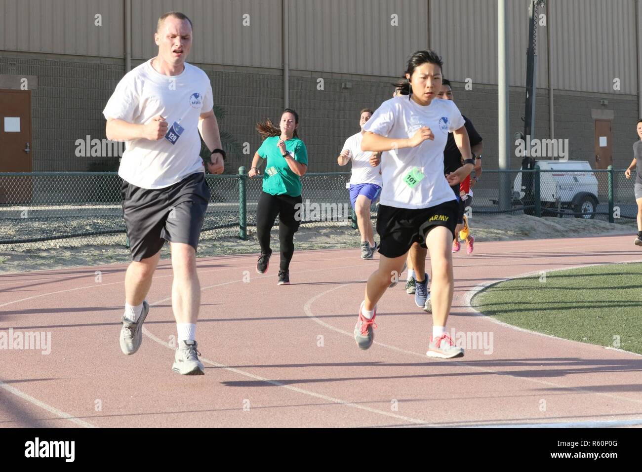 U.S. Servicemembers dash to the finish line at the Army Reserve 5k Walk or Run, April 22, at Camp Arifjan, Kuwait. The Army Reserve Engagement Cell hosted this annual event, as part of a celebratory day geared to honoring the men and women who serve in the U.S. Army Reserves. Stock Photo