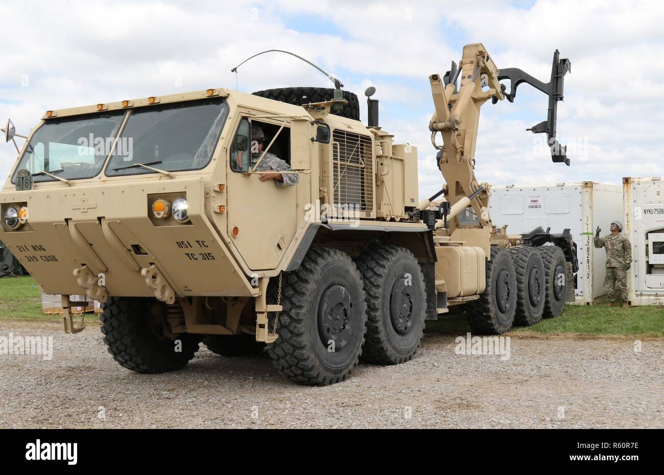 Members of the U.S Army Reserve 851st Transportation Company, based in Sinton, Texas, use a M1075A1 Palletized Load System to deliver a refrigerated conex during Vibrant Response and Guardian Response near Camp Atterbury, Indiana, Apr. 25, 2017.  Vibrant Response and Guardian Response bring together military, federal and state agencies from throughout the continental U.S. for three weeks of collective training simulating the response to a catastrophic Chemical Biological Radiological Nuclear (CBRN) event in a major U.S. city. Stock Photo