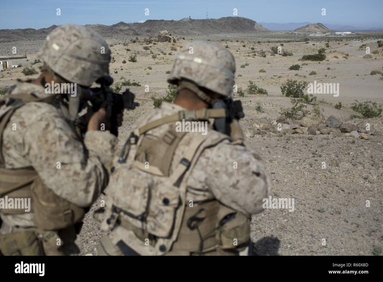 U.S. Marines with weapons platoon, Fox Company, 2nd Battalion, 7th Marine  Regiment, Special Purpose Marine Air - Ground Task Force - Crisis Response  - Central Command, stand on-line while conducting a live 
