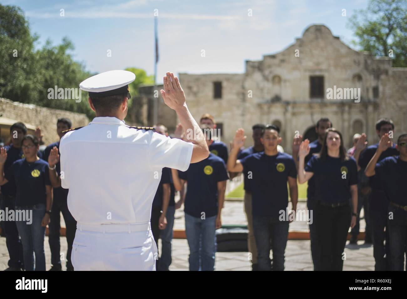 SAN ANTONIO, Texas (April 27, 2017) Capt. Edgardo Moreno, executive officer of the amphibious transport dock ship USS San Antonio (LPD 17), administers the oath of enlistments to more than 15 future Sailors during Navy Day at the Alamo. Seven Sailors from the ship, including the executive officer and the command master chief, are visiting their ship's namesake for community outreach and Fiesta San Antonio 2017. Stock Photo