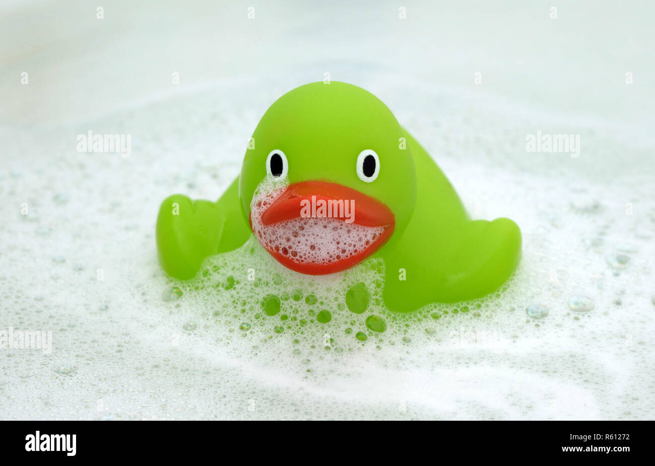 Green duck in a bathtub, surrounded by soap Stock Photo - Alamy
