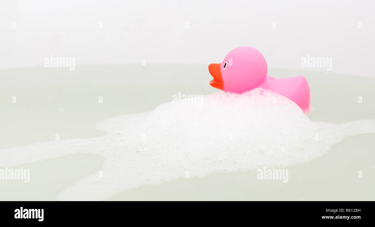 Pink duck in a bathtub, surrounded by soap Stock Photo - Alamy
