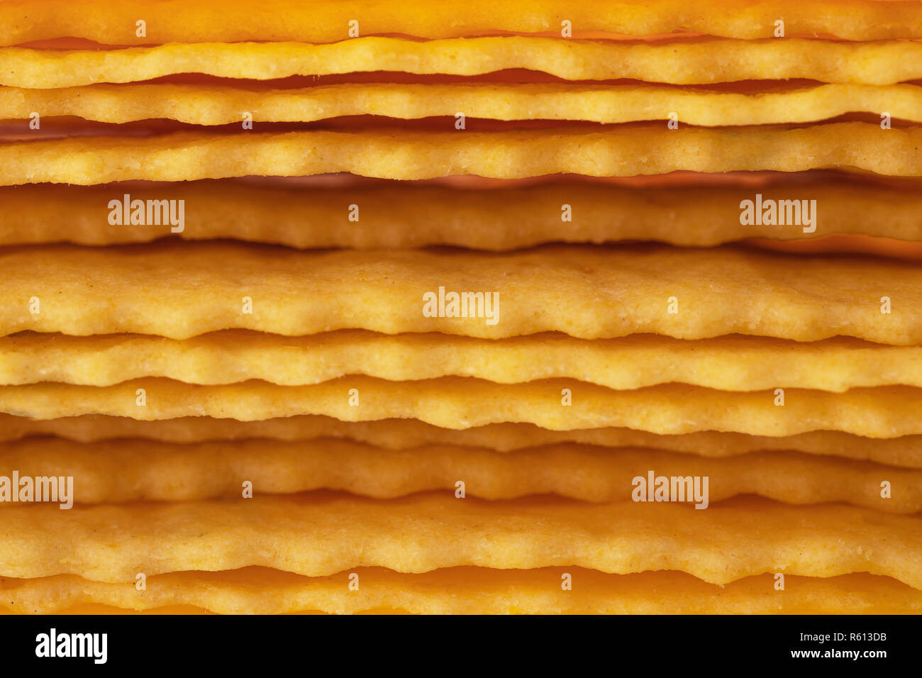 Cheese crackers freshly baked as texture background. Stock Photo