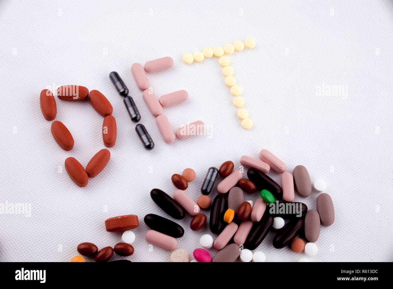 Hand writing text caption inspiration Medical care concept written with pills drugs capsule word DIET On white isolated background with copy space Stock Photo