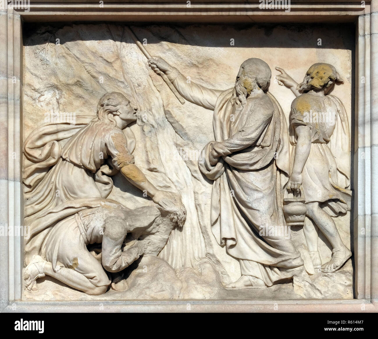Moses strikes water from the stone, marble relief on the facade of the Milan Cathedral, Duomo di Santa Maria Nascente, Milan, Lombardy, Italy Stock Photo