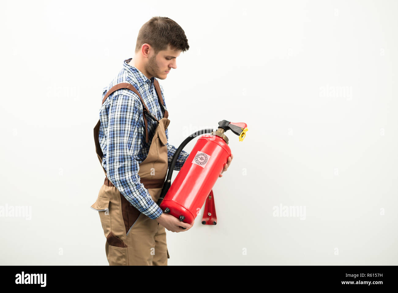 Technician Carrying Red Fire Extinguisher Stock Photo Alamy