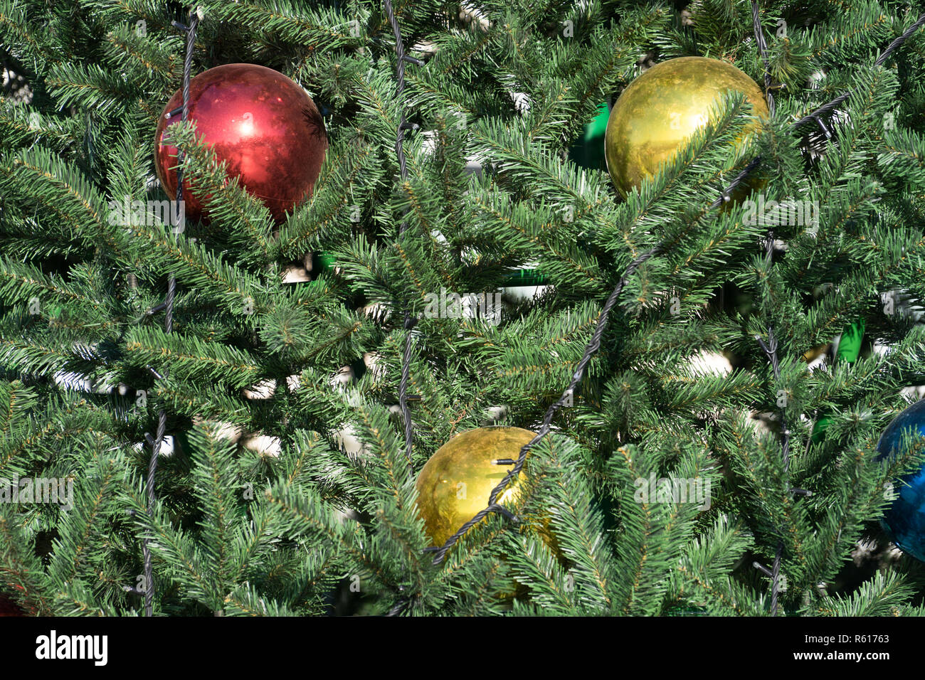 background with artificial fir branches and colored balls Stock Photo