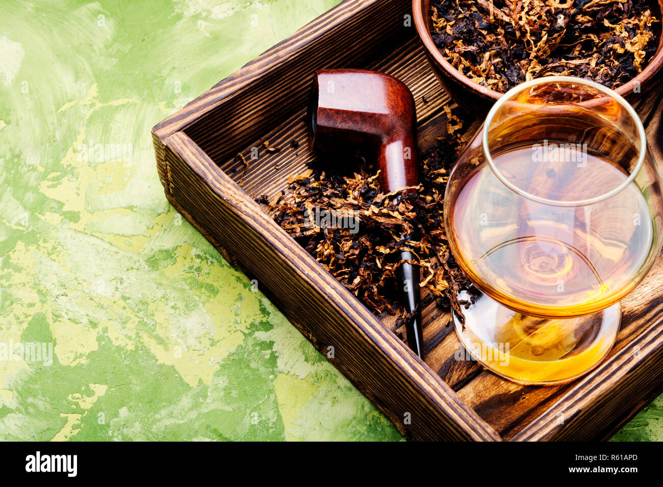 Glass of cognac and pipe with tobacco Stock Photo Alamy