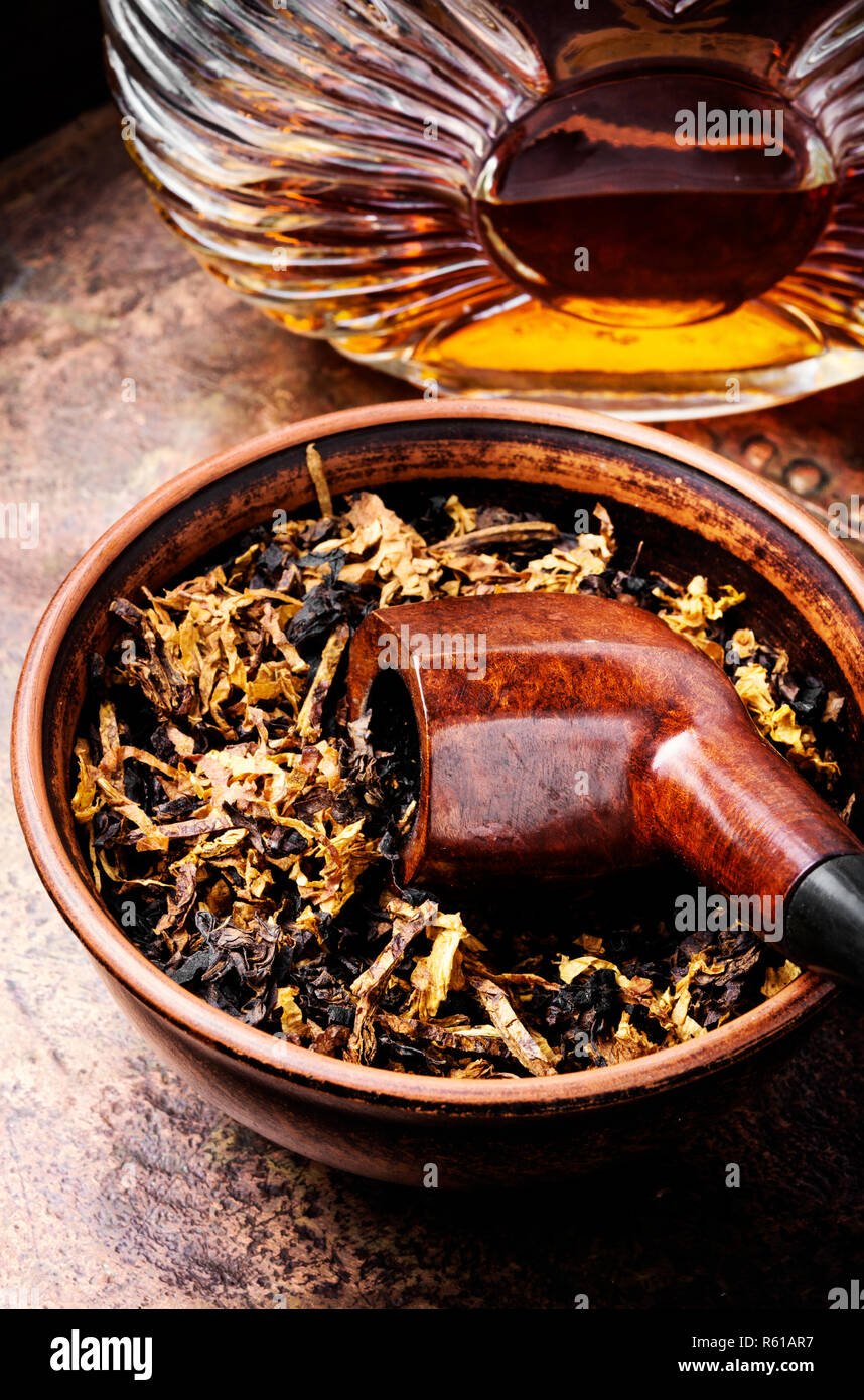Glass of cognac and pipe with tobacco Stock Photo Alamy