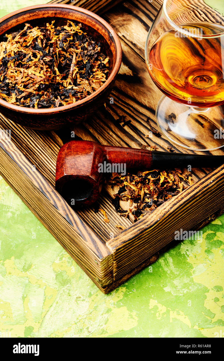 Glass of cognac and pipe with tobacco Stock Photo Alamy
