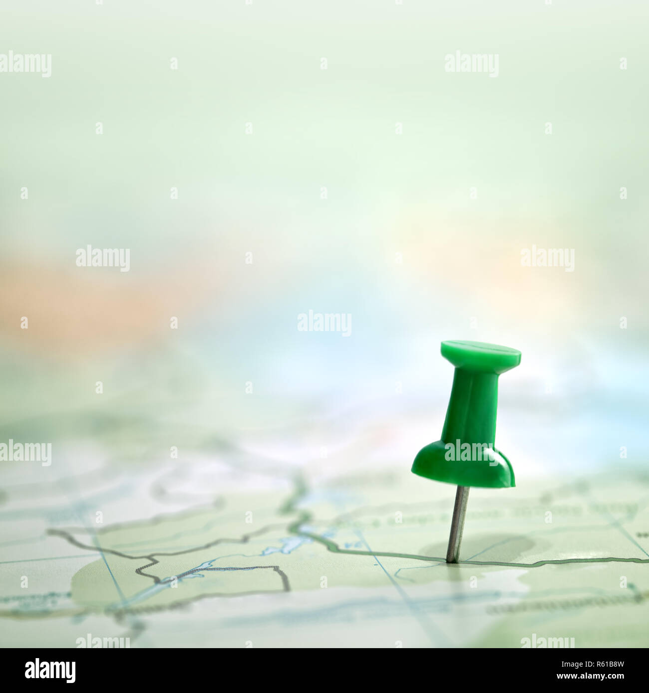 Pushpin showing the location of a destination point on a green map Stock Photo