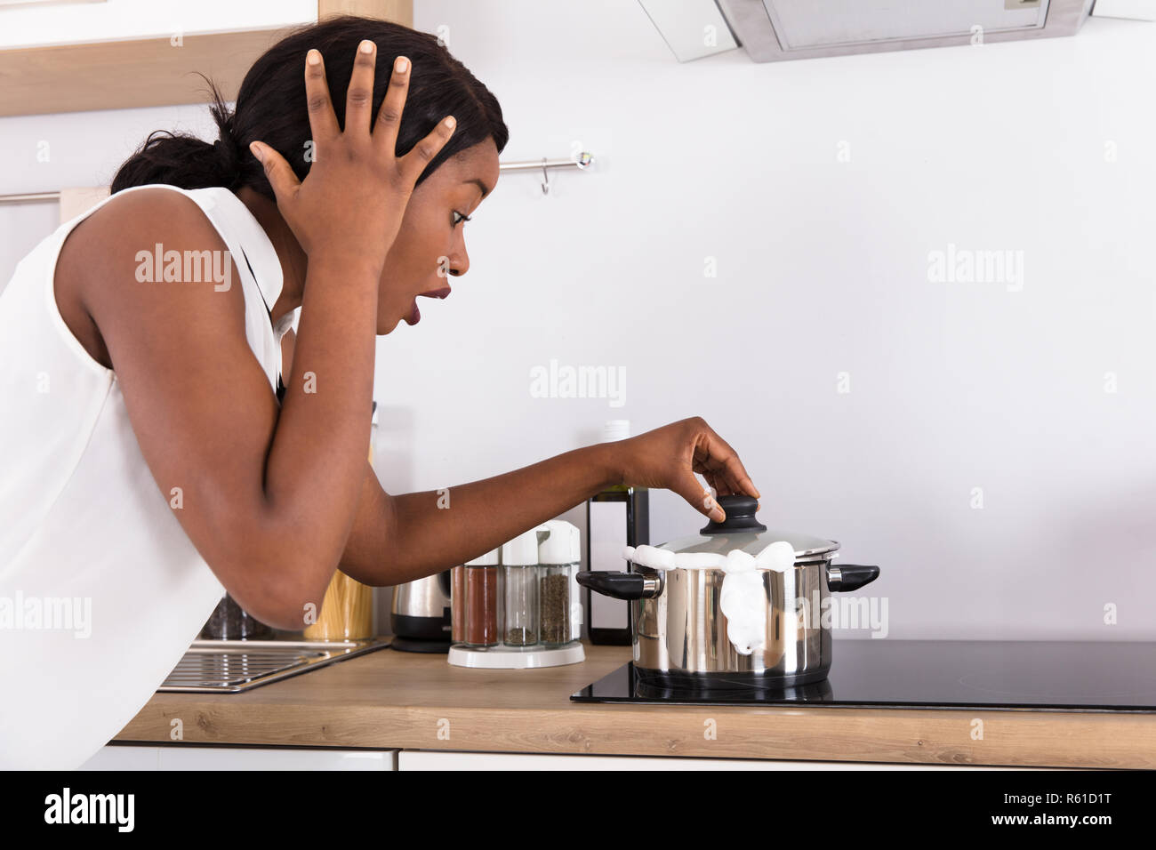 Woman Looking At Spilling Out Boiled Milk From Utensil Stock Photo Alamy