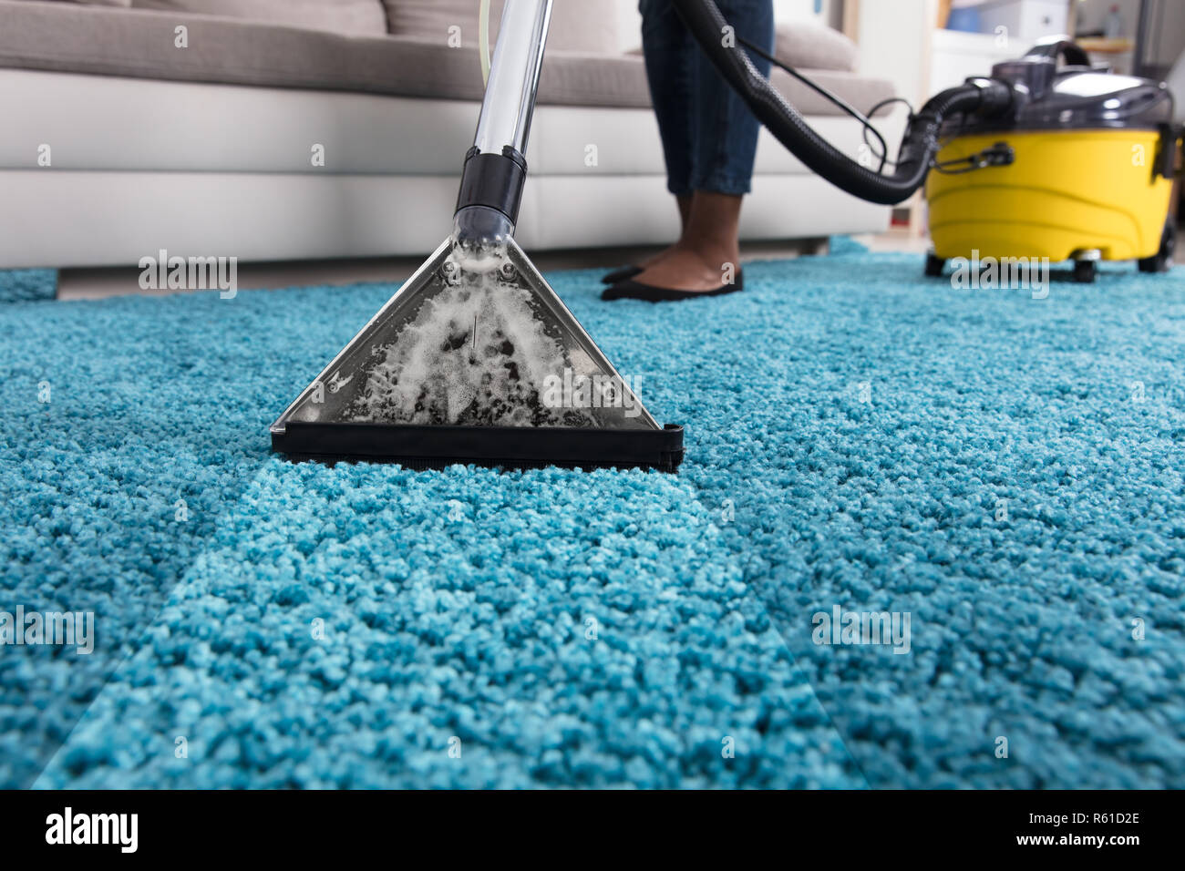 Person Using Vacuum Cleaner For Cleaning Carpet Stock Photo Alamy