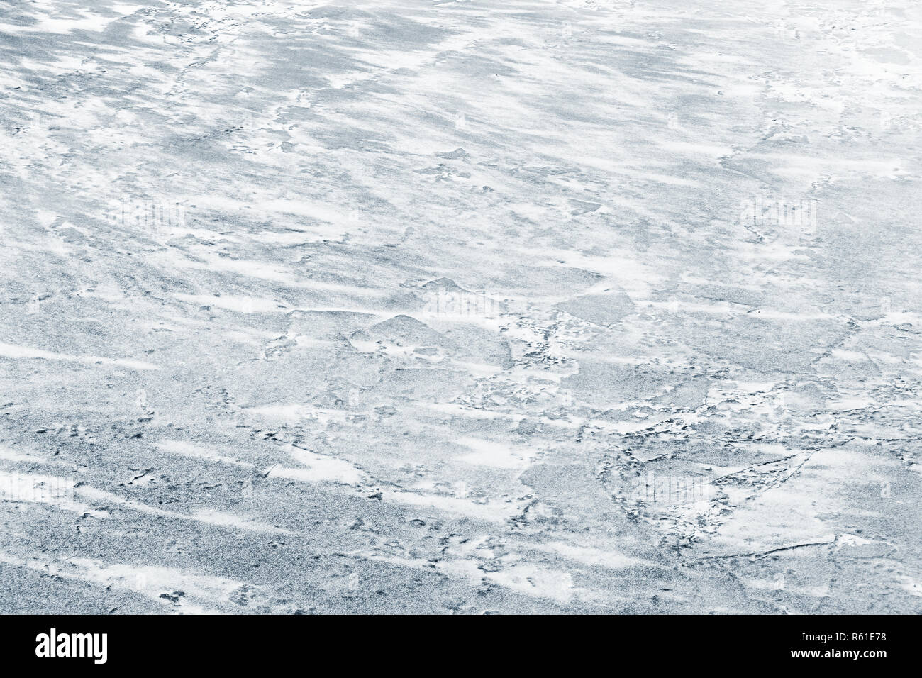 Ice surface covered with show on frozen river in winter season, natural background photo texture Stock Photo